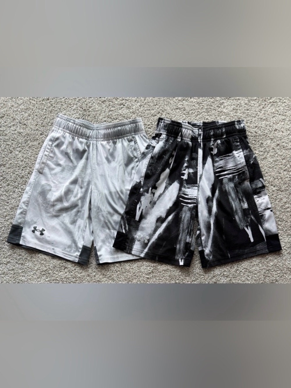 Two pairs of Under Armour loose fit shorts size youth small.